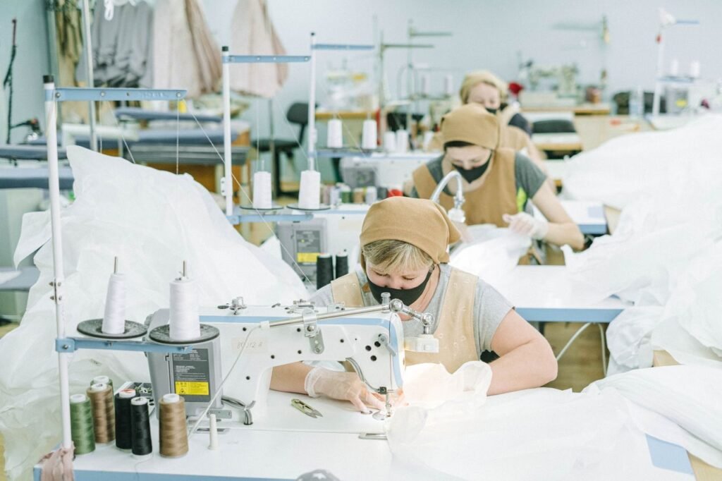 Apparel manufacturing production line with sewing operators