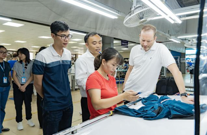 Apparel professionals evaluating garment production at a factory