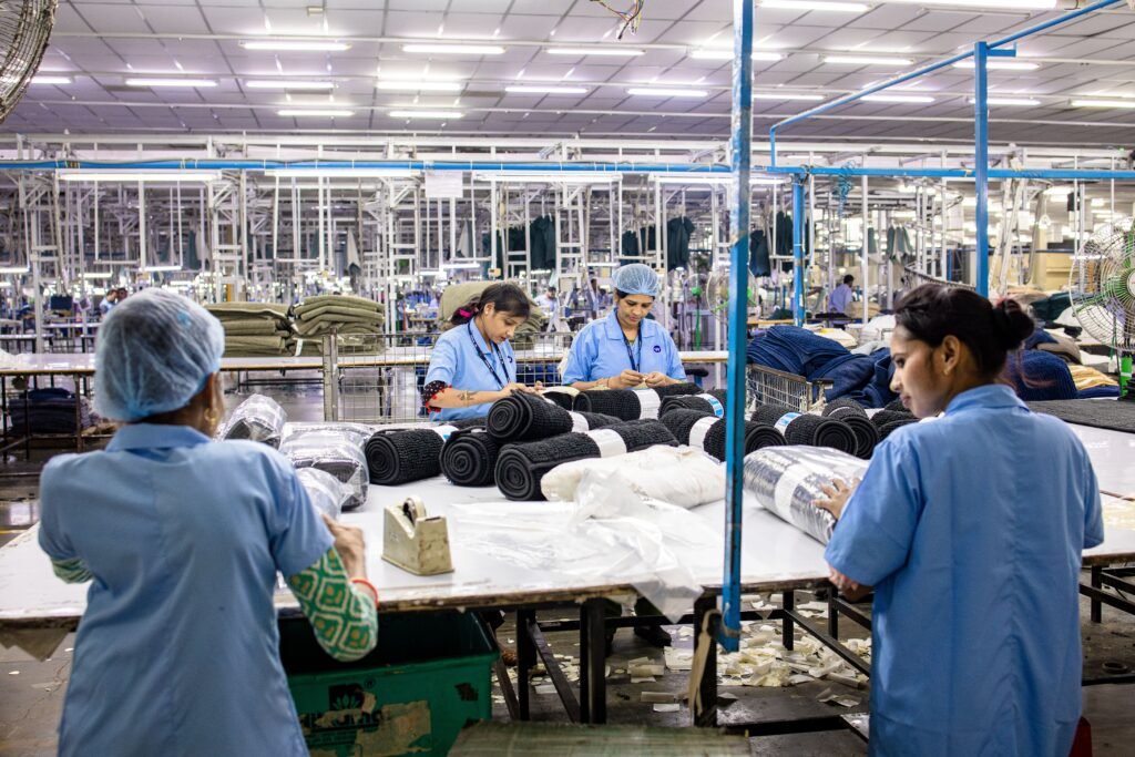 Apparel production workers handling garments during quality control and rework